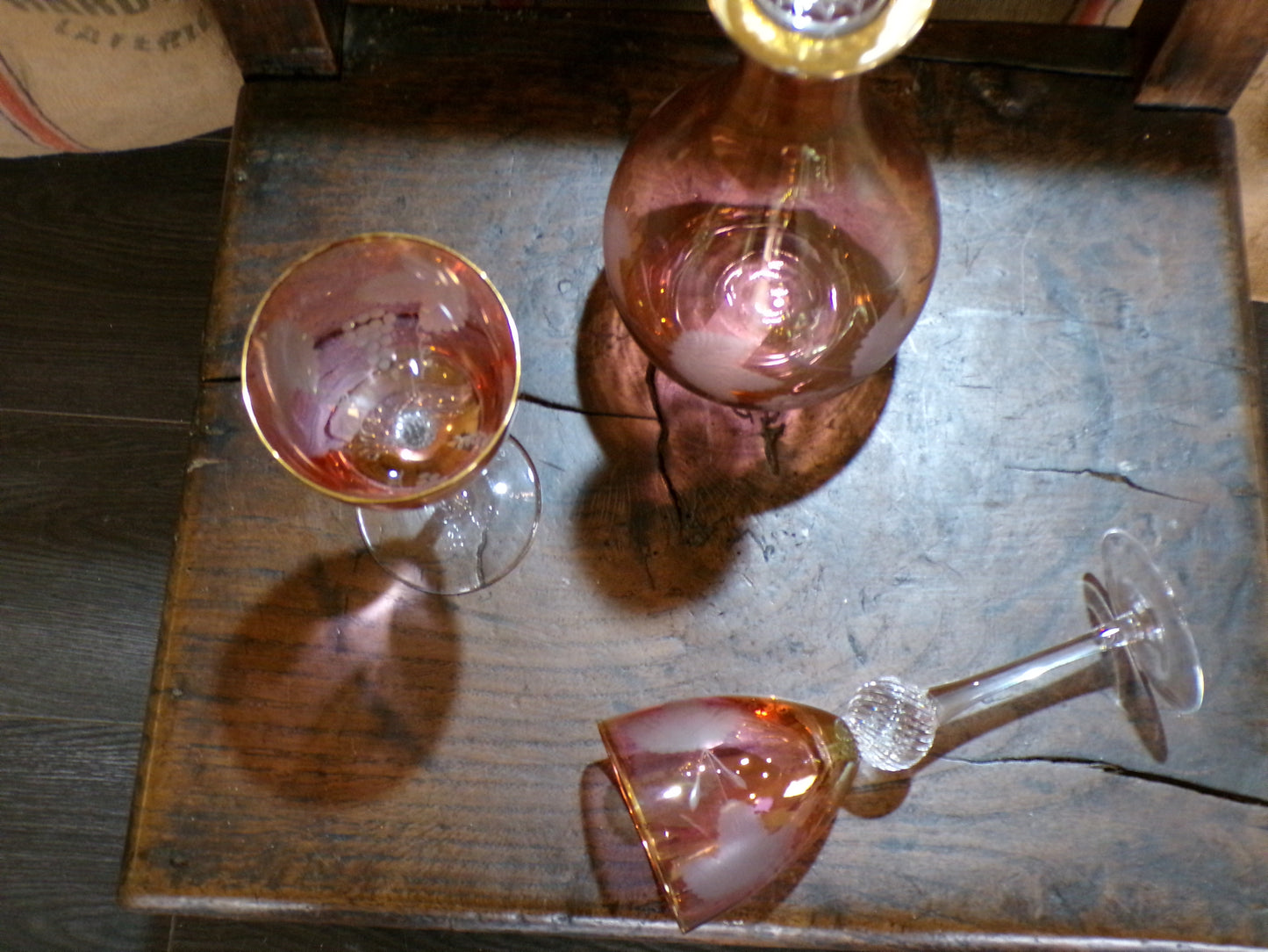 Three set Murano red and gold lustre mid century caraffe and wine glass set.