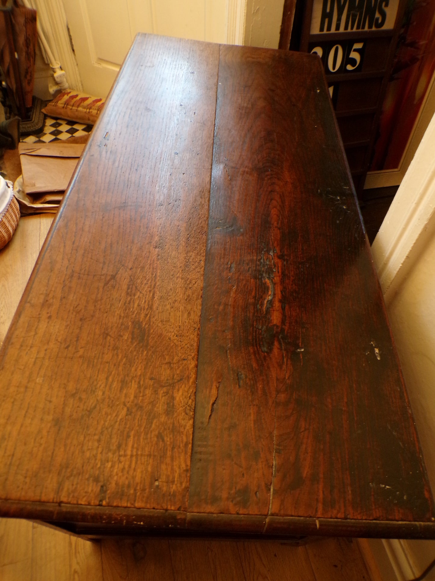Seventeenth Century oak coffer with tulip and leafage carving surrounding two geometric mouldedpanels.
